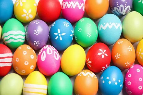 Colorful Easter eggs with different patterns as background, top view 库存照片
