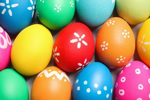 Colorful Easter eggs with different patterns as background, top view 库存照片