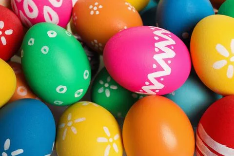 Colorful Easter eggs with different patterns as background, top view 库存照片