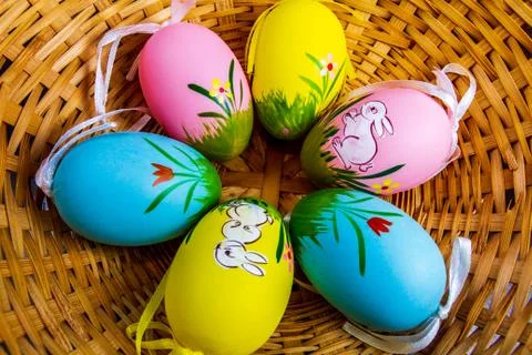 Colorful easter eggs with drawings in a basket isolated Stock Photos