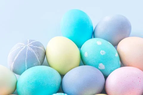 Colorful Easter eggs dyed by colored water isolated on a pale blue background Foto stock