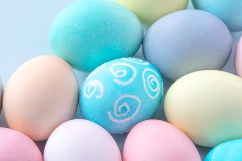 Colorful Easter eggs dyed by colored water isolated on a pale blue background Foto stock