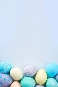 Colorful Easter eggs dyed by colored water with beautiful pattern on a pale b Stock Photos