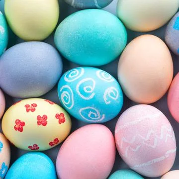 Colorful Easter eggs dyed by colored water with beautiful pattern on a pale b 写真素材