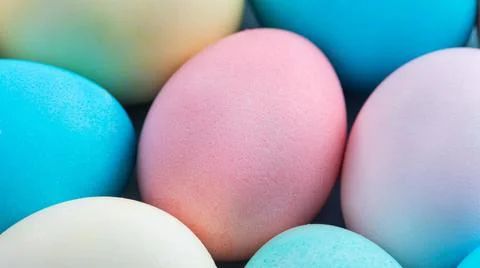 Colorful Easter eggs dyed by colored water with beautiful pattern on a pale b Stock Photos