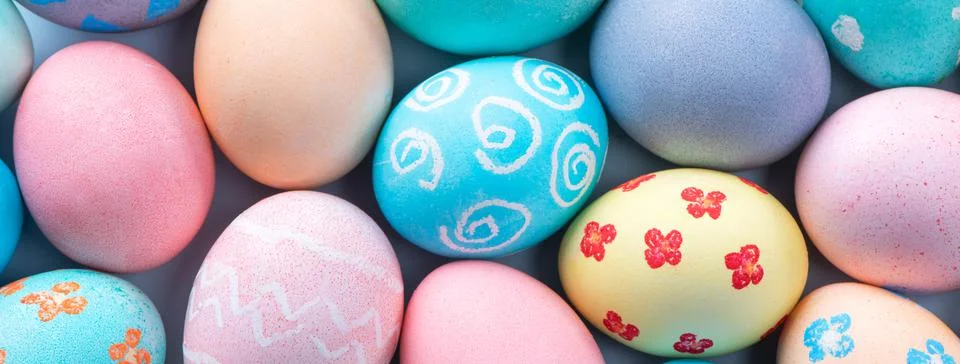 Colorful Easter eggs dyed by colored water with beautiful pattern on a pale b Stock Photos