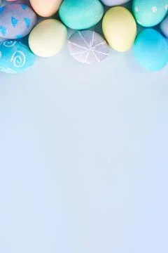 Colorful Easter eggs dyed by colored water with beautiful pattern on a pale b 写真素材