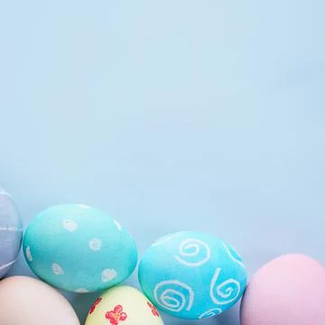 Colorful Easter eggs dyed by colored water with beautiful pattern on a pale b 写真素材