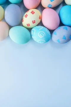 Colorful Easter eggs dyed by colored water with beautiful pattern on a pale b Stock Photos