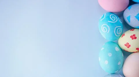 Colorful Easter eggs dyed by colored water with beautiful pattern on a pale b Stock Photos