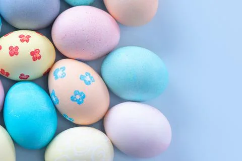 Colorful Easter eggs dyed by colored water with beautiful pattern on a pale b Stock Photos