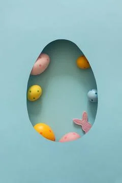 Colorful Easter eggs with Easter felt bunny silhouette inside egg shaped cu.. Stock Photos