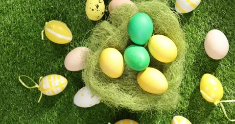Colorful Easter eggs on the grass. Top view rotating of colorful easter eggs Stock Footage 175395818