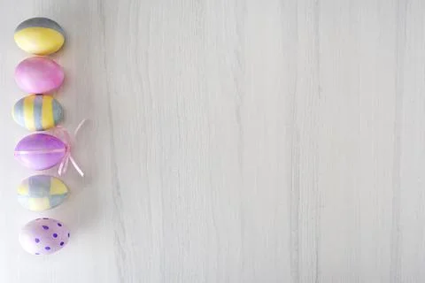 Colorful easter eggs on gray table with place for text, top view Stock Photos