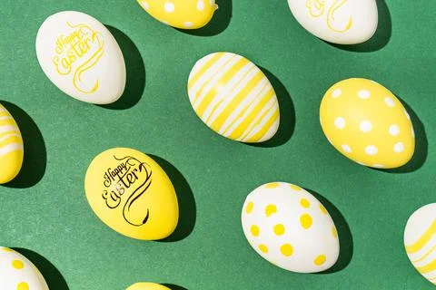 Colorful easter eggs on a green background hard light black shadows hard shad Stock Photos