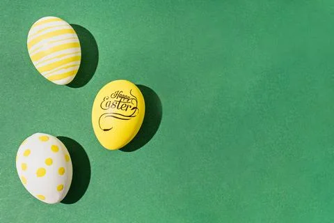 Colorful easter eggs on a green background hard light black shadows hard shad Stock Photos