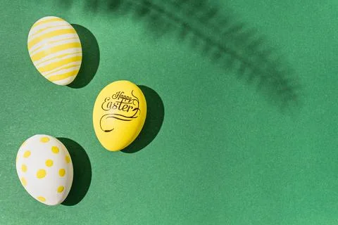 Colorful easter eggs on a green background hard light black shadows hard shad Stock Photos