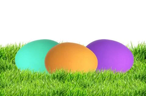 Colorful Easter Eggs in green grass isolated on white Fotos Stock