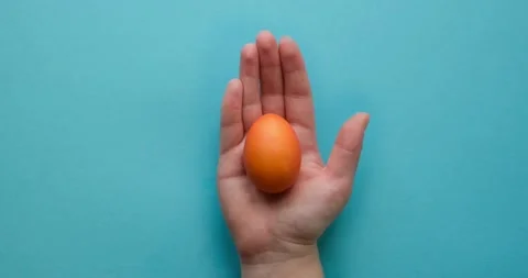Colorful Easter eggs in a hand. Looped 4K stop motion animation Stock Footage 235812007
