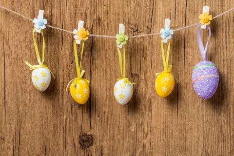 Colorful Easter eggs hanging on ribbons Stock Photos