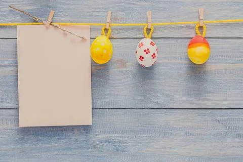 Colorful easter eggs hanging on a yellow clothesline Stock Photos