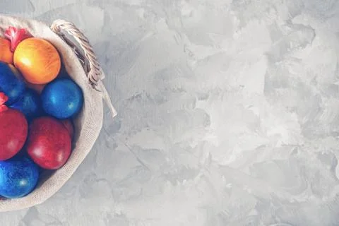 Colorful easter eggs lying in a basket on a beautiful vintage background. Vie Stock Photos