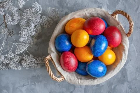 Colorful easter eggs lying in a basket on a beautiful vintage background. Vie Stock Photos