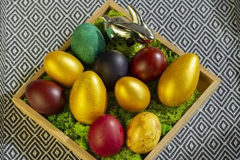 Colorful Easter eggs on the moss, top view Foto stock