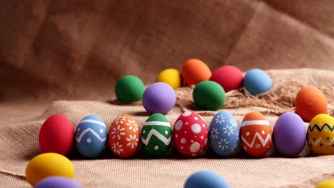 Colorful easter eggs on natural burlap, Dolly shot. Happy Easter Day. Stock Footage 149050536