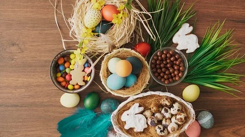 Colorful Easter eggs in nest and spring flowers on wooden table. Easter holid 動画素材 124464953
