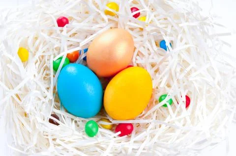 Colorful Easter eggs in nest on white background Stock Photos