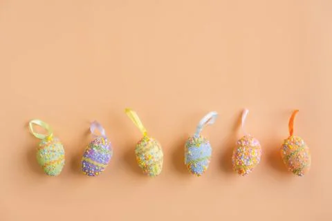 Colorful easter eggs on orange background with copy space, Top view 库存照片