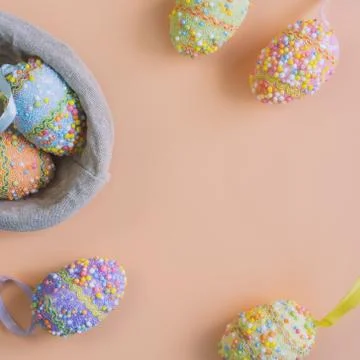 Colorful easter eggs on orange background with copy space, Top view Stock Photos