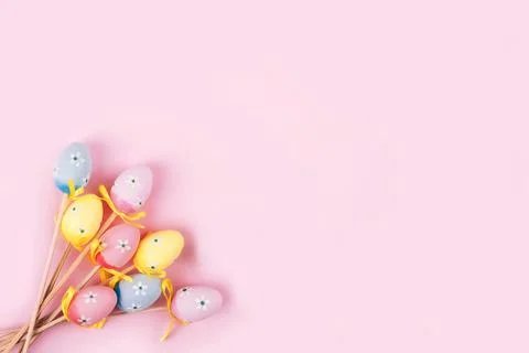 Colorful Easter eggs over pink background. Stock Photos