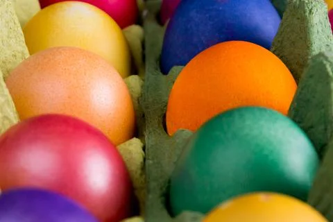 Colorful easter eggs in paper egg carton Stock Photos