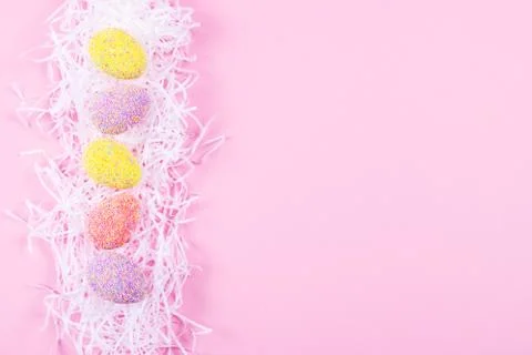 Colorful easter eggs on pink background. Stock Photos