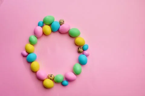 Colorful easter eggs on pink background, top view Stock Photos
