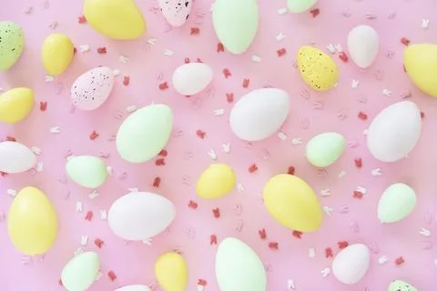 Colorful Easter eggs on pink background. Egg hunting. Stock Photos