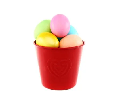 Colorful easter eggs in a red bucket. Stock Photos