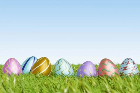 Colorful Easter eggs resting on green grass under a clear sky Illustrazione stock