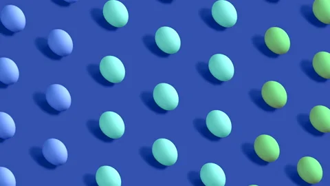 Colorful Easter Eggs rotating in rows in seamless loop on blue background Stock Footage 150045822