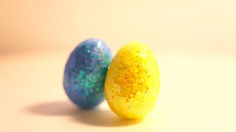 Colorful Easter eggs rotating in rows in a seamless loop on a light background 스톡 사진