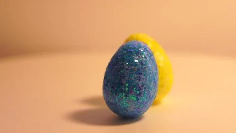 Colorful Easter eggs rotating in rows in a seamless loop on a light background 스톡 사진
