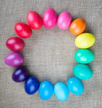 Colorful easter eggs round frame on sackcloth background Stock Photos