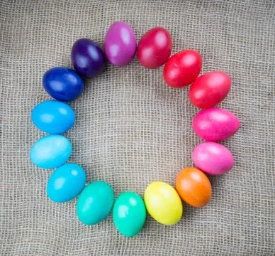 Colorful easter eggs round frame on sackcloth background Stock Photos