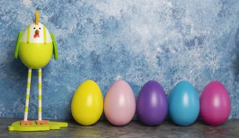 Colorful Easter eggs in a row and eggs in form of chicks with long legs on a  Stock Photos