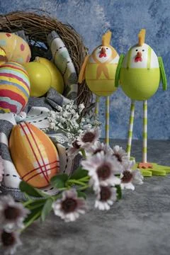 Colorful Easter eggs in row and eggs in form of chicks standing beside Stock Photos