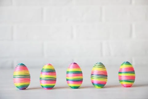 Colorful easter eggs in row on white background Stock Photos