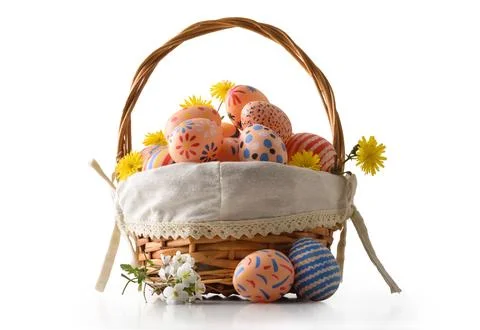 Colorful Easter Eggs in Rustic Wicker Basket Stock Photos