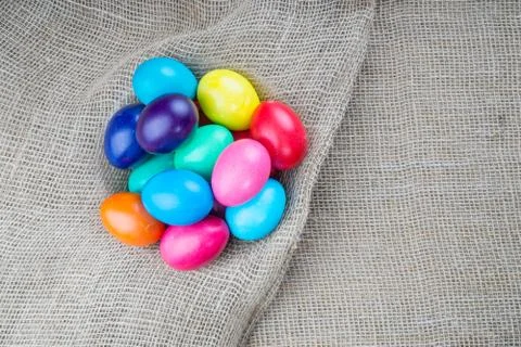 Colorful easter eggs on sackcloth background Stock Photos